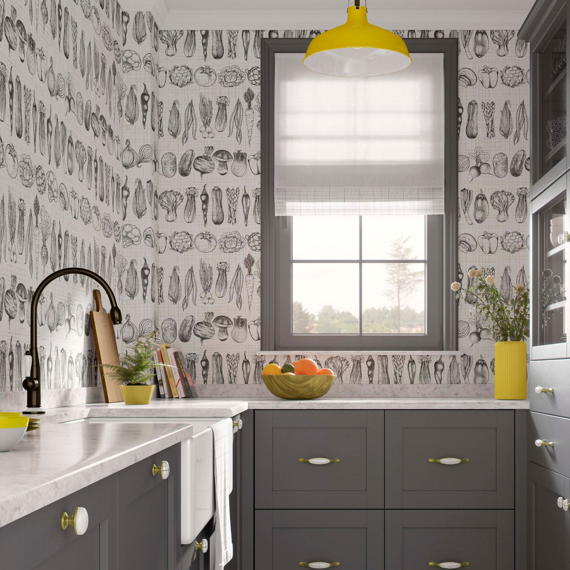 Modern kitchen with charcoal grey cabinets, white marble countertops, and wallpaper featuring black and white hand-drawn vegetable sketches. A bright yellow pendant light hangs above a window with a grey frame.