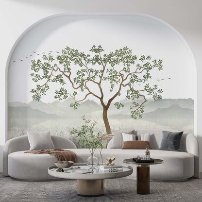 cat-610569683272  A stylish living room featuring a scenic nature wallpaper mural with a large tree inside a large wall arch behind a curved sofa.