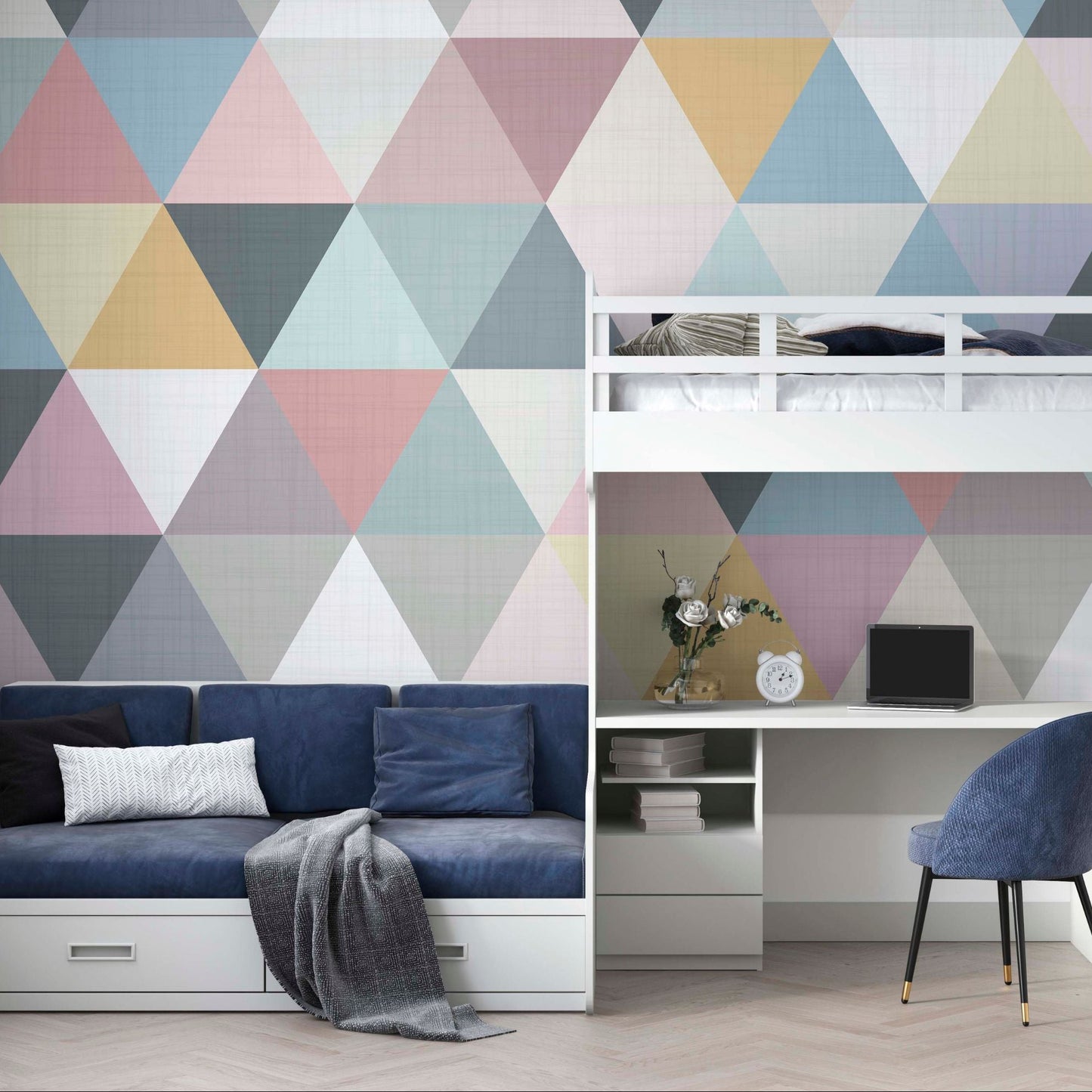cat-661212758344 A teenager's bedroom featuring a pastel geometric triangle wallpaper mural behind a white loft bed with a built-in desk, a navy blue sofa bed, and matching blue walls.