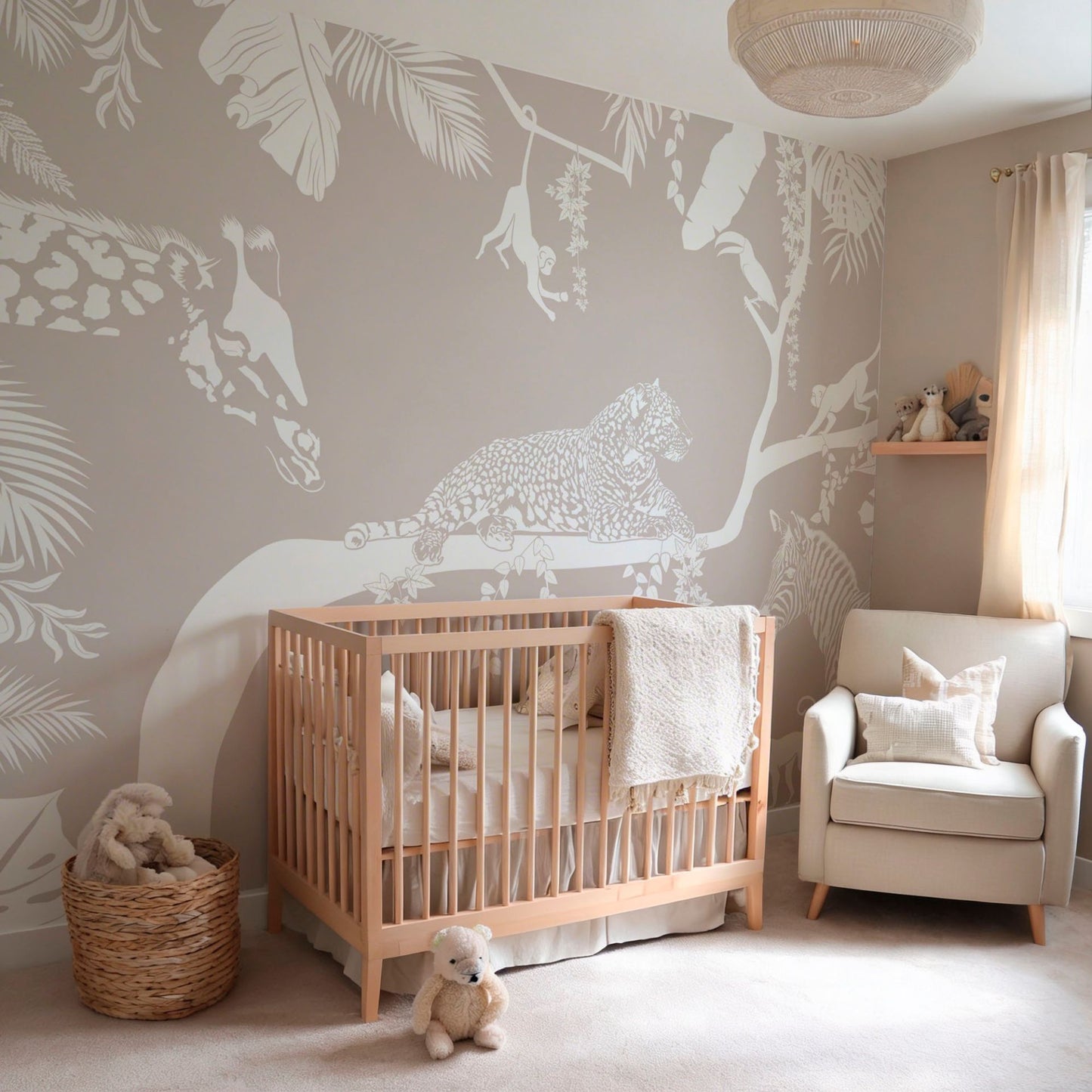 Neutral jungle animal wallpaper mural in a cozy nursery with crib and armchair