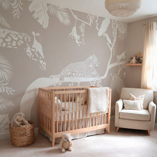 Neutral jungle animal wallpaper mural in a cozy nursery with crib and armchair
