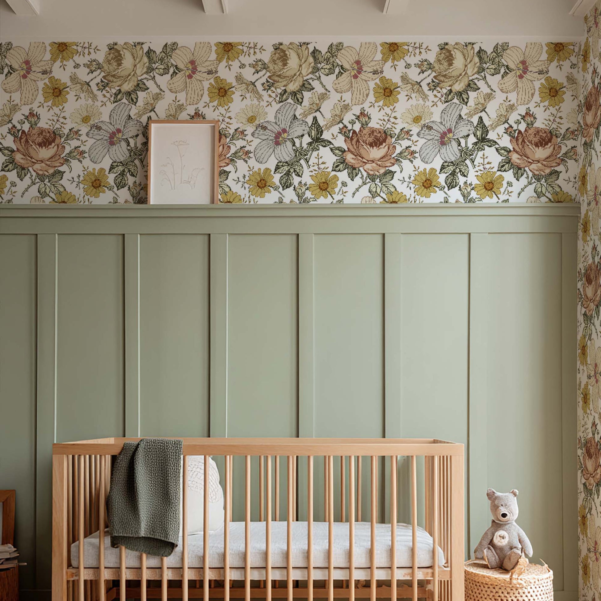 cat-615198294344 Baby nursery featuring vintage floral wallpaper in ochre and dusty pink tones, sage green wainscoting, a natural wood crib, and warm rustic decor.