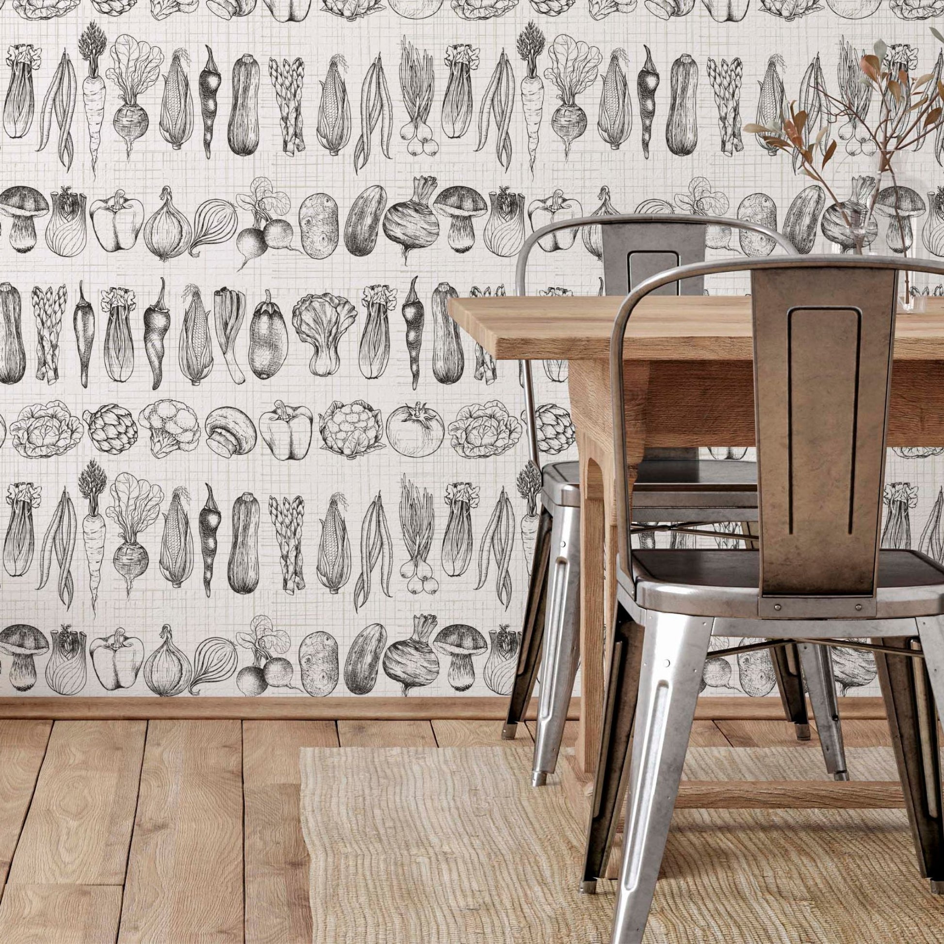 cat-659356549448  Rustic dining room featuring a wooden table and galvanized metal chairs against a wall with black and white vegetable sketch wallpaper. The floor is light wood with a jute rug.