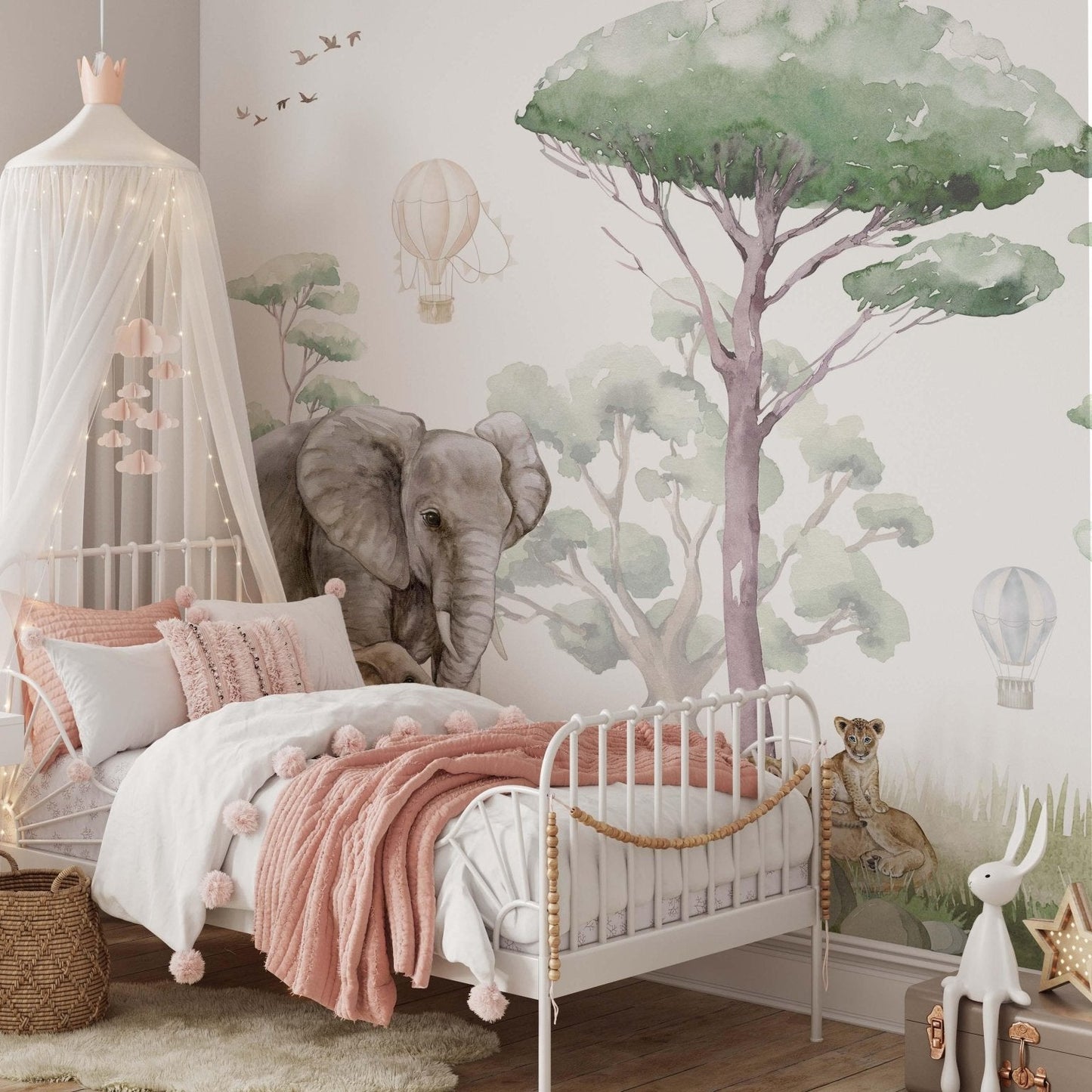 Safari Animals wallpaper mural in a girls' bedroom with canopy bed, featuring watercolor elephant, lion cubs and hot air balloons in soft sage green tones