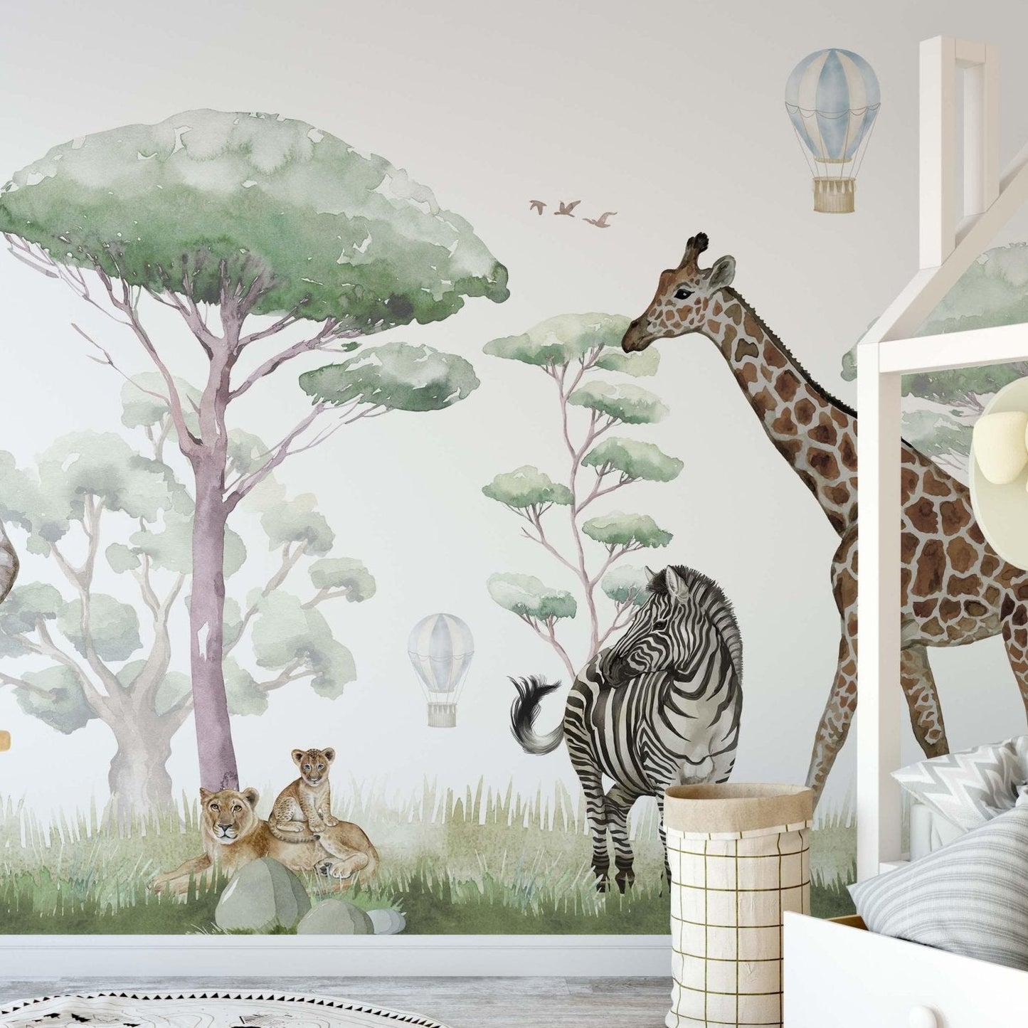Safari Animals wallpaper mural in a nursery with house-shaped bed, zebra, giraffe and lion cubs in soft sage green watercolor tones