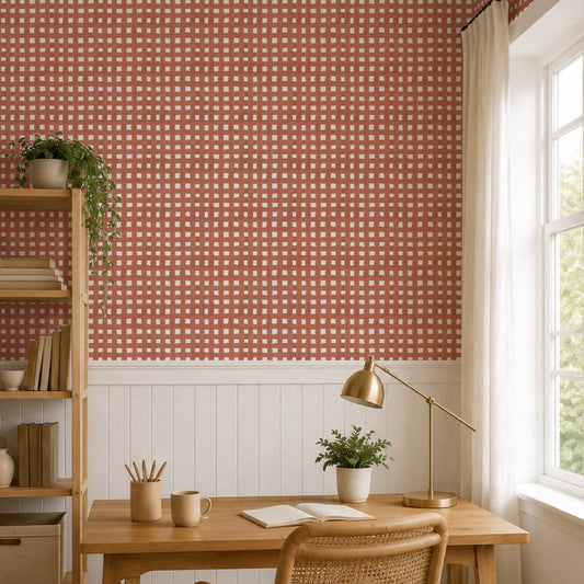 cat-610804433224 Minimal Scandinavian home office with terracotta gingham wallpaper, wooden desk, woven chair, and white wainscoting.