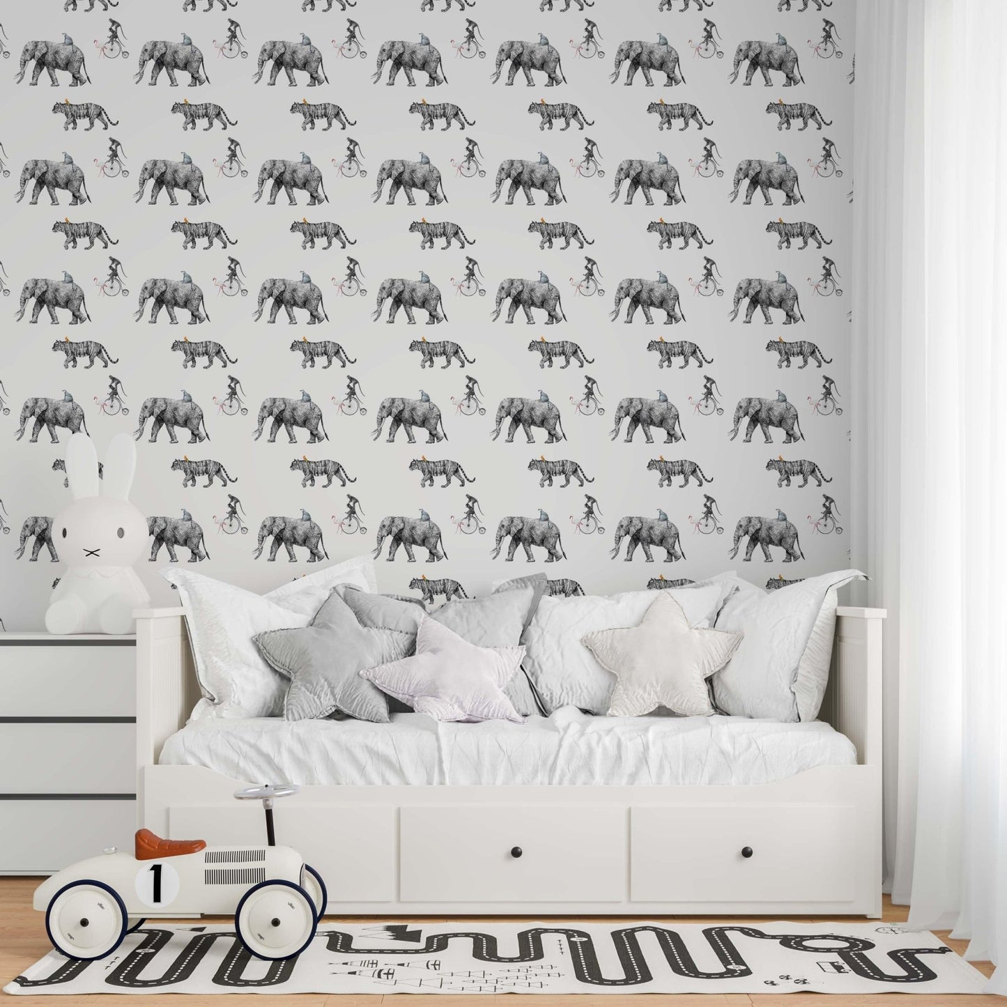 Modern nursery featuring Tropical Animals sketch wallpaper with a grey hand-drawn pattern of elephants and safari animals above a white daybed