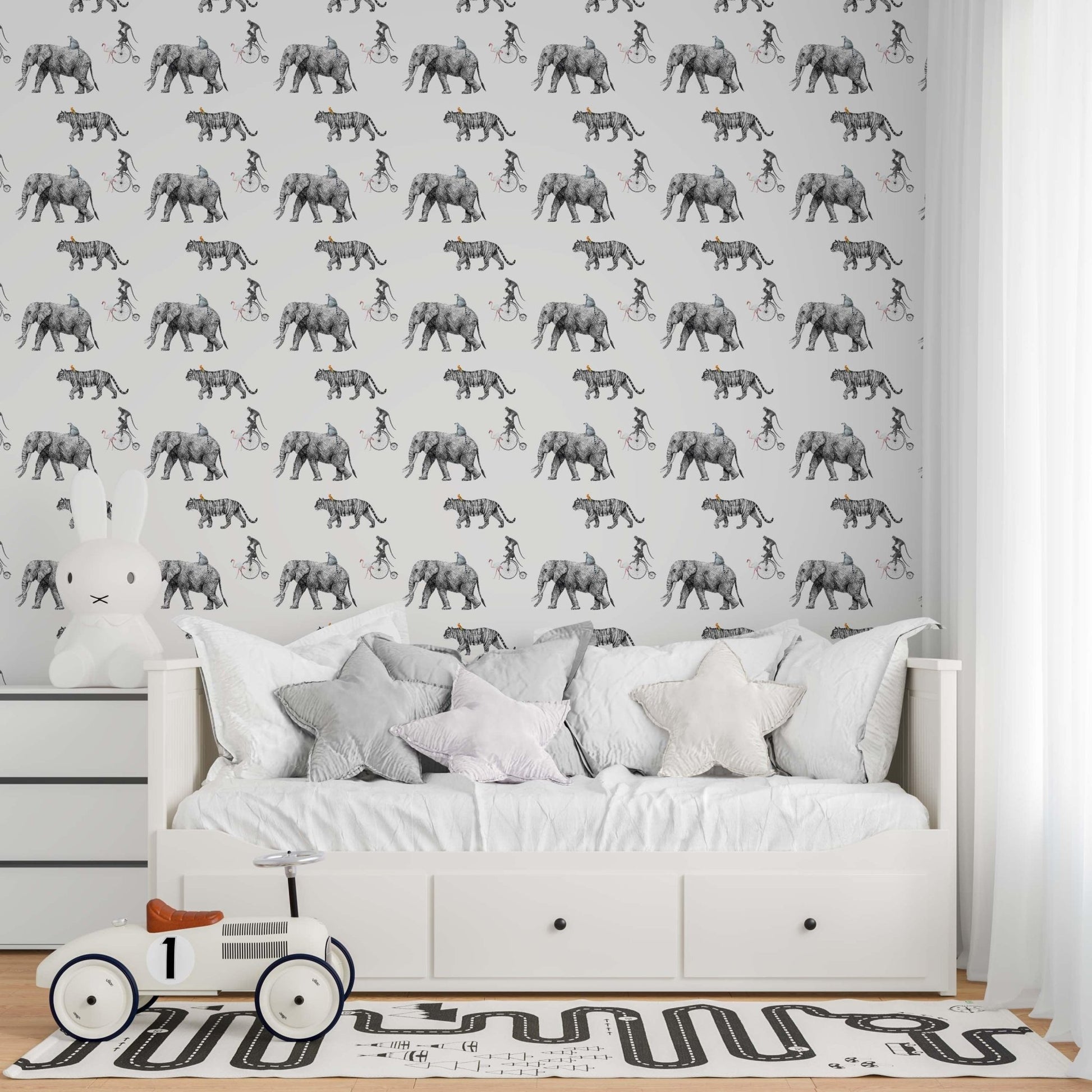 Modern nursery featuring Tropical Animals sketch wallpaper with a grey hand-drawn pattern of elephants and safari animals above a white daybed