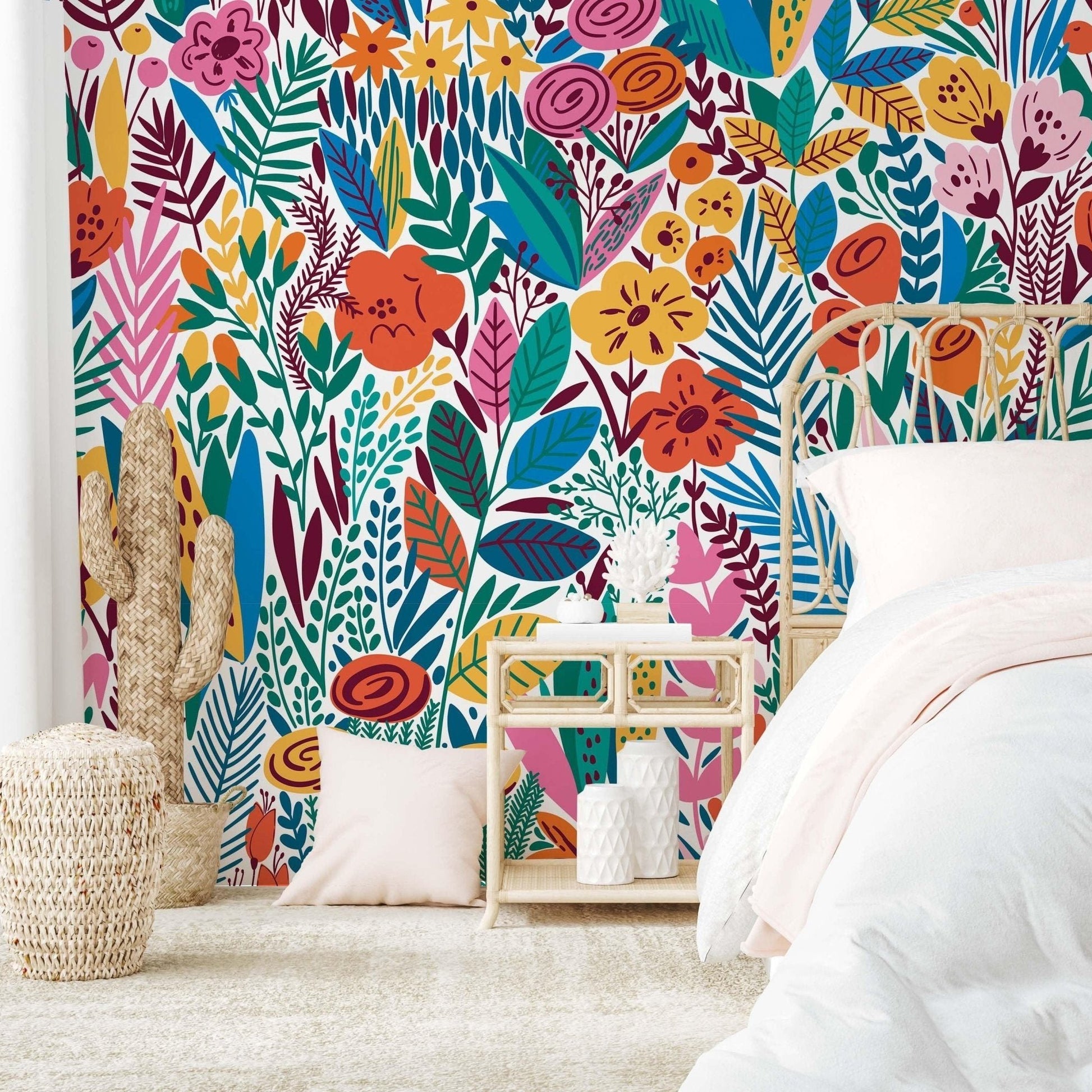 Colorful floral wallpaper with bold, oversized flowers and leaves in shades of orange, pink, green, and blue, adding a cheerful touch to a bedroom interior.