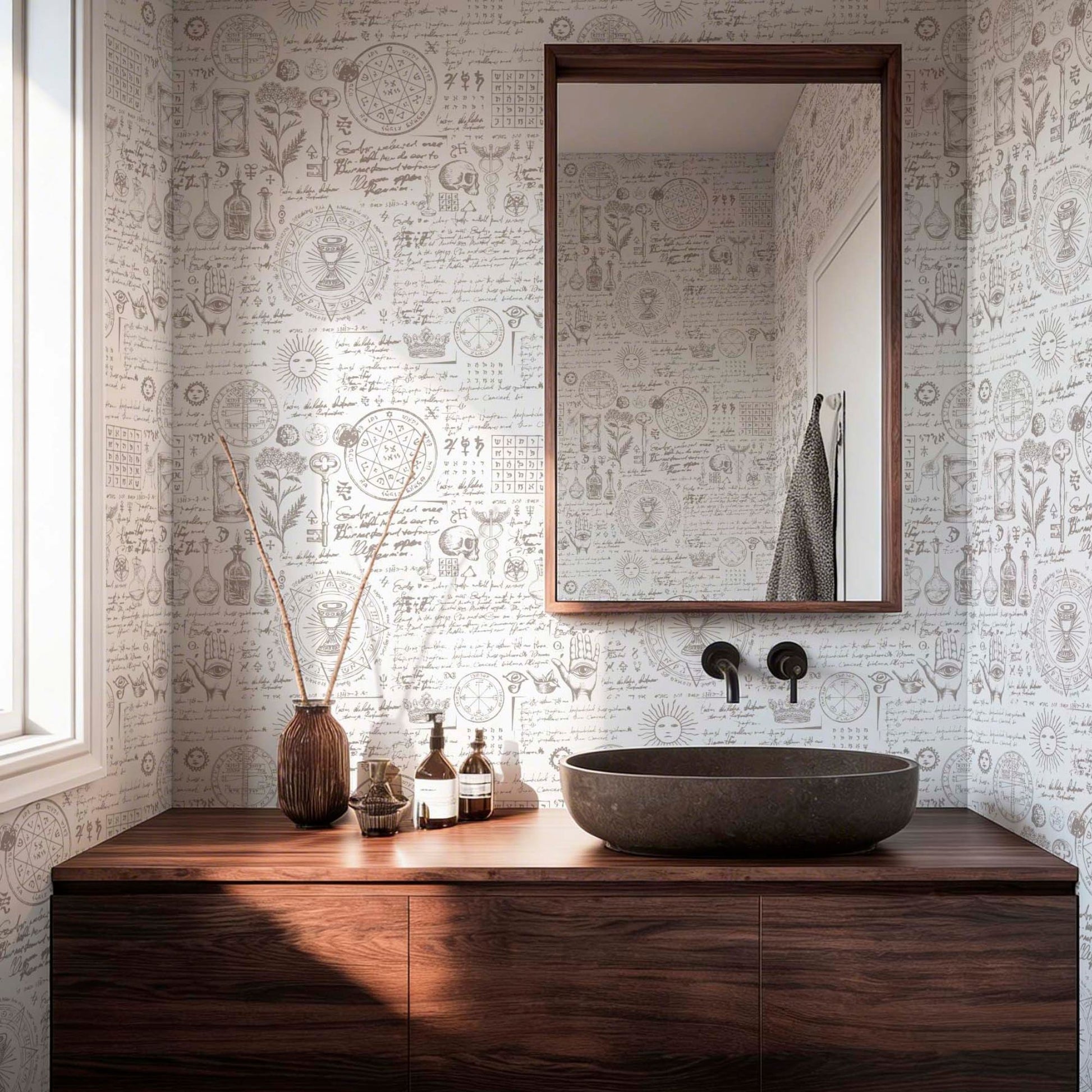 Vintage alchemy and apothecary themed wallpaper in a modern bathroom with a dark wood vanity, stone vessel sink, and botanical sketches.