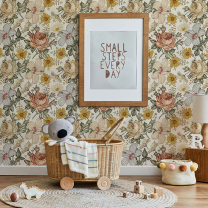 Cozy nursery with vintage floral wallpaper in yellow and pink, a wooden frame with the quote "Small steps every day," a rattan basket on wheels with a koala plush, and a round jute rug