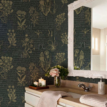 Elegant bathroom featuring dark charcoal wallpaper with vintage botanical sketches and gold cursive script, a large white ornate mirror, and a bathroom vanity decorated with candles and pink flowers