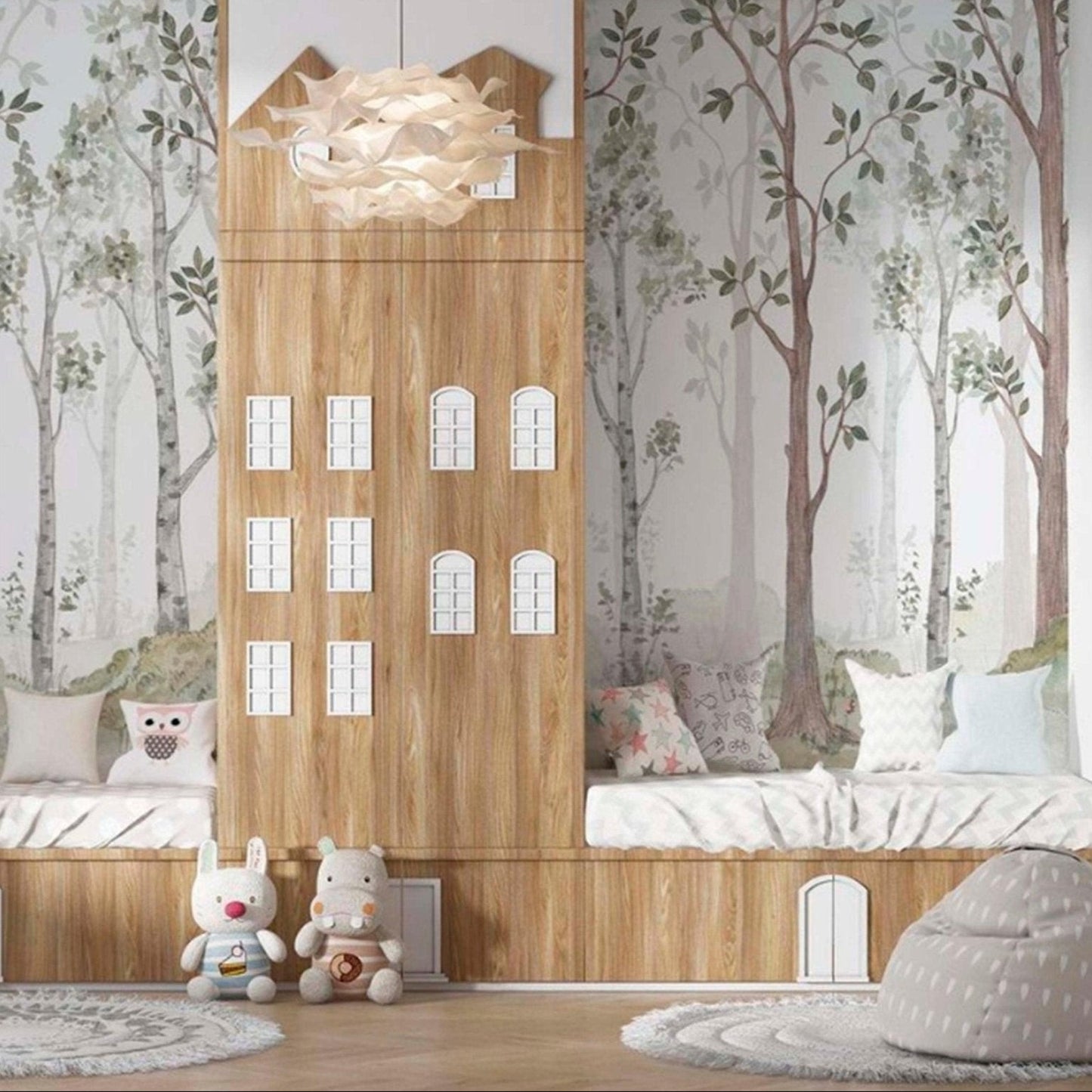 cat-661212758344 A children's playroom featuring a watercolor forest wallpaper mural backdrop behind custom wood built-in beds and cabinets styled with plush toys and patterned cushions.