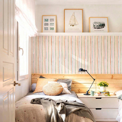 Bright and cozy bedroom featuring earth-toned watercolor stripe wallpaper on the main wall with light wood headboard and neutral bedding.