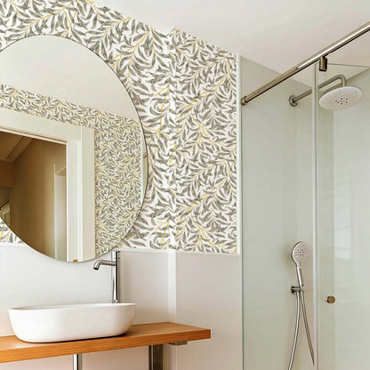 cat-610804236616 Modern bathroom with Willow Leaf wallpaper in soft olive and mustard tones, paired with natural wood accents and a minimalist vanity.
