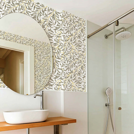 cat-610804236616 Modern bathroom with Willow Leaf wallpaper in soft olive and mustard tones, paired with natural wood accents and a minimalist vanity.