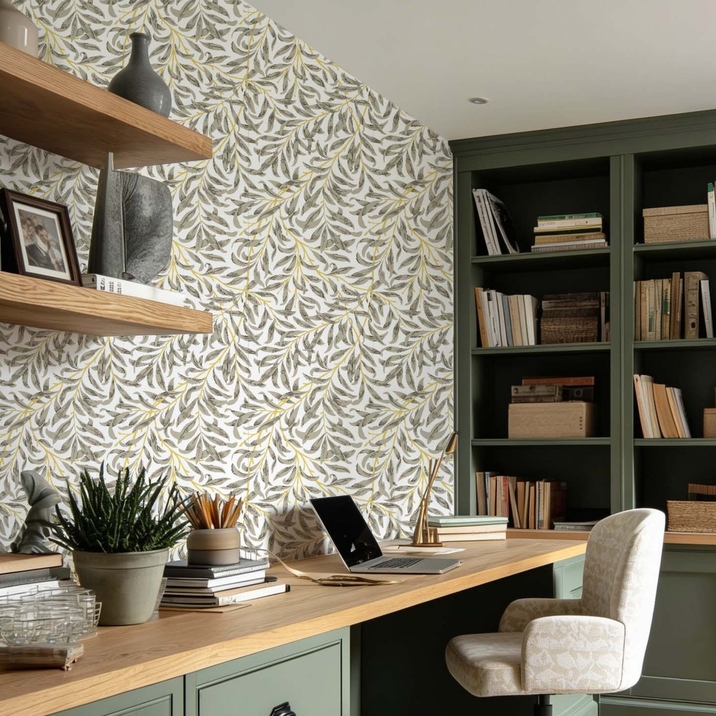 cat-610804433224 Home office with Willow Leaf wallpaper, green built-in cabinets and natural wood desk, creating a warm and timeless workspace.