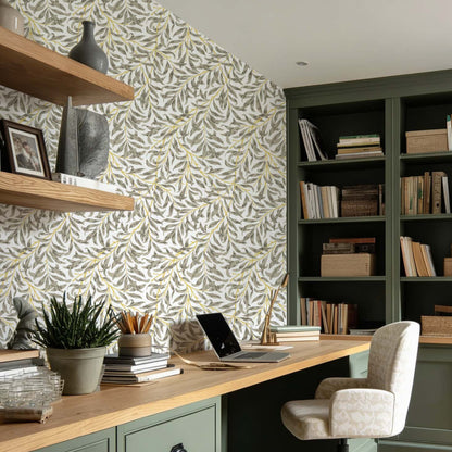 cat-610804433224 Home office with Willow Leaf wallpaper, green built-in cabinets and natural wood desk, creating a warm and timeless workspace.