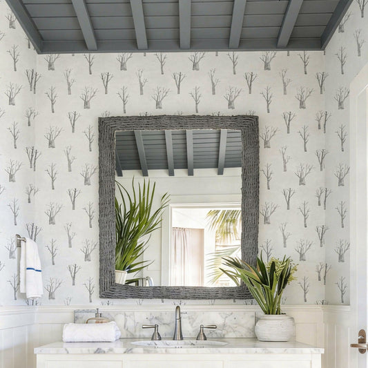 cat-610804236616 Powder room with winter trees wallpaper in grey and white, white vanity and elegant sconces.