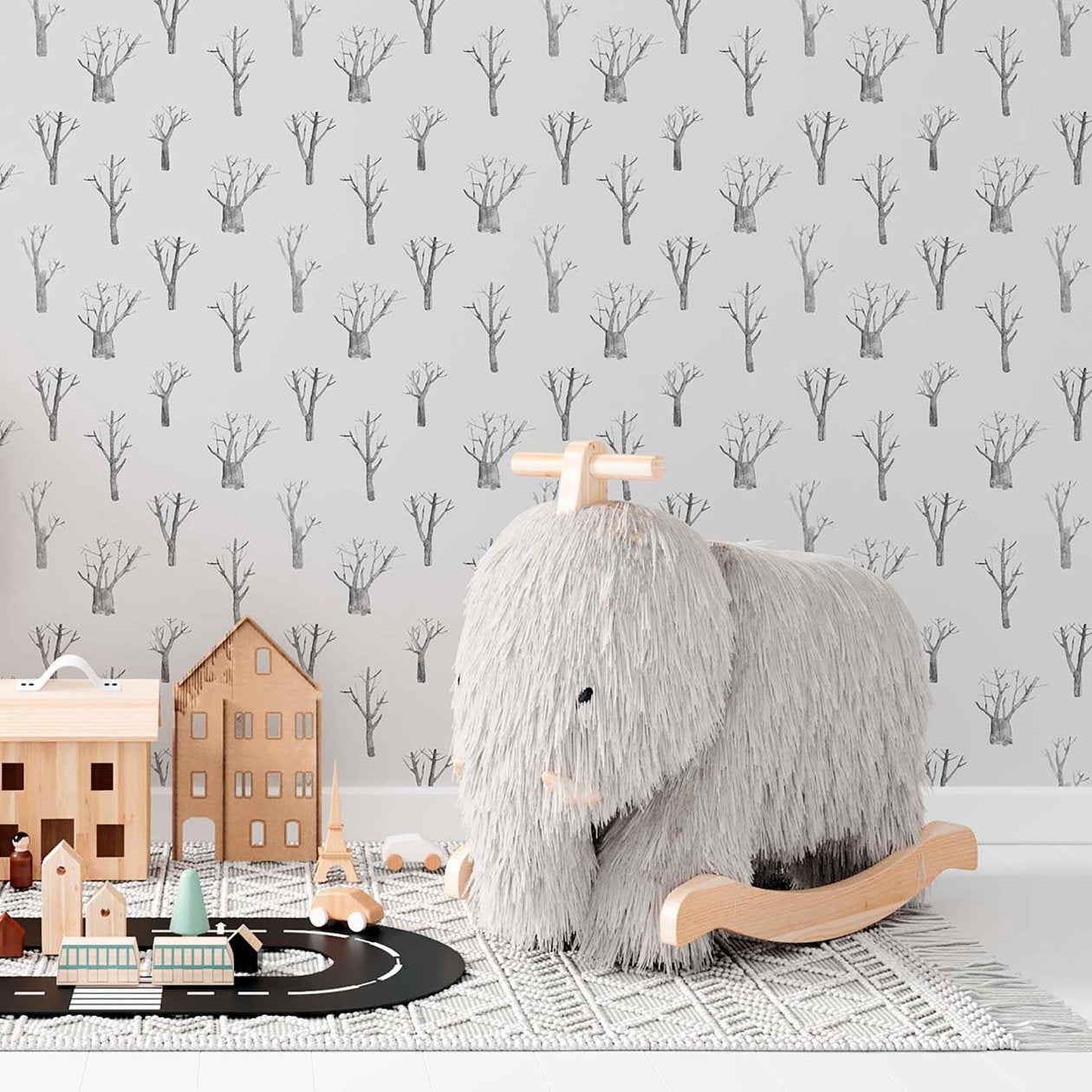 Kids room with winter trees wallpaper in grey and white, neutral gender-friendly decor.