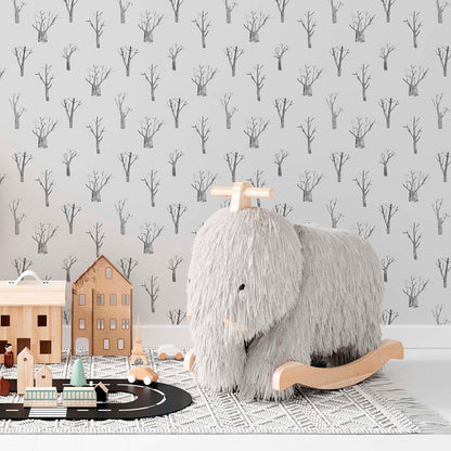 Kids room with winter trees wallpaper in grey and white, neutral gender-friendly decor.