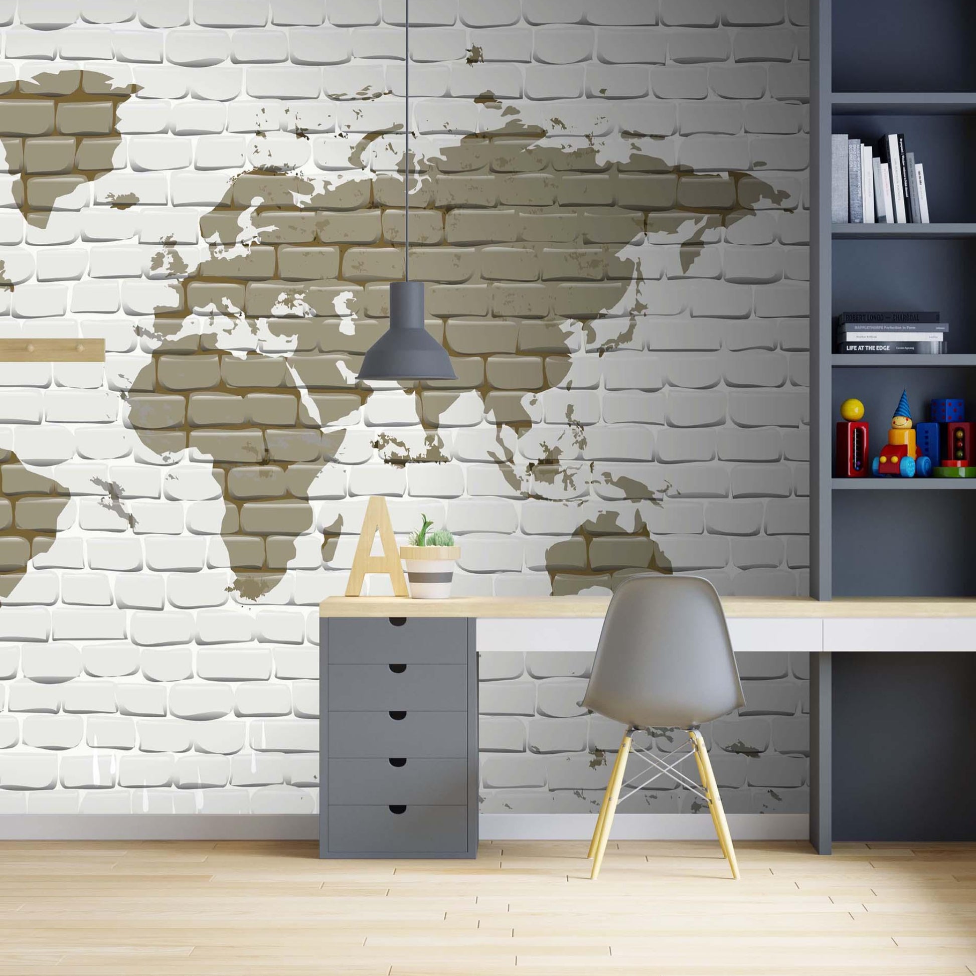 cat-660961526088 World map wallpaper on a white brick wall behind a grey desk with a Nordic chair and a book shelf.