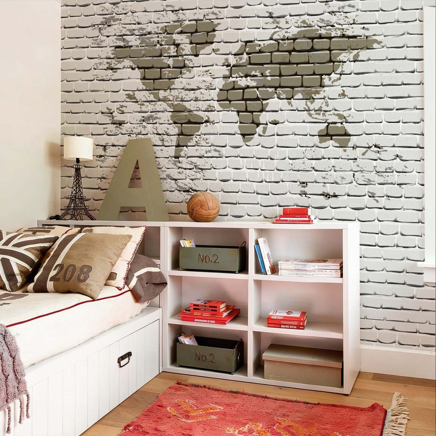 World map wallpaper on a white brick wall installed in a teenager's bedroom next to a white bed and bookshelf.