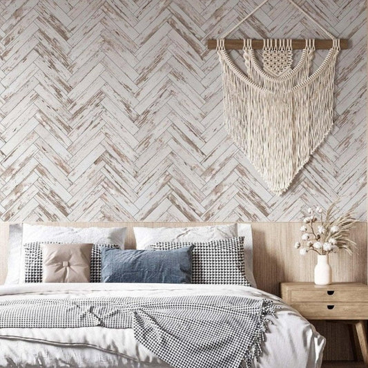 cat-616983200072 Bedroom featuring a white herringbone faux wood wallpaper accent wall with a bohemian macramé hanging and rustic wooden furniture.
