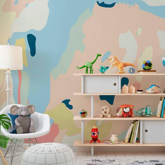 cat-610568044872 Modern kids playroom interior featuring an abstract pastel wall mural behind a wooden shelf with dinosaur toys and books.